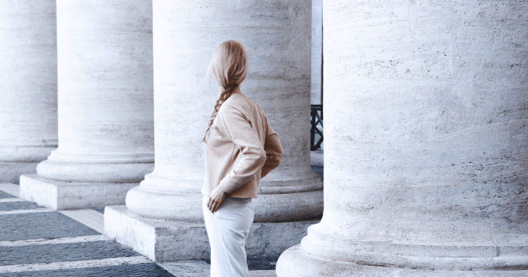 Woman standing in front of pillars
